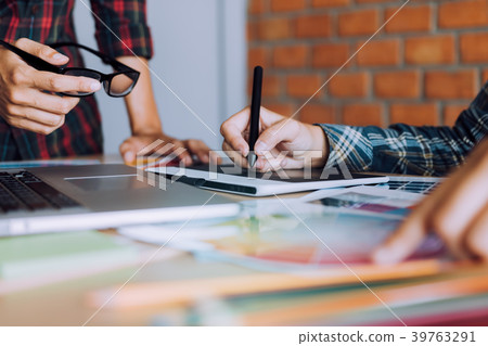 Co-worker working with graphic design in office Co-worker working with graphic design in office 39763291