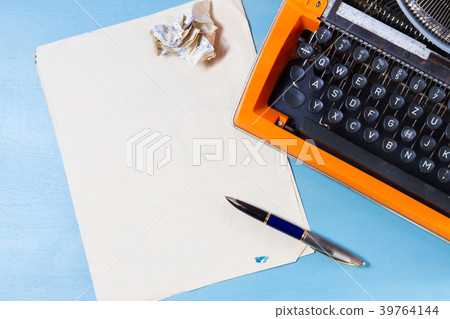Workspace with vintage orange typewriter 39764144
