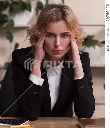 Young woman working in office, sitting at desk 39766426