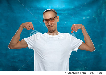 Cute man posing on blue background Cute man posing on blue background 39767386