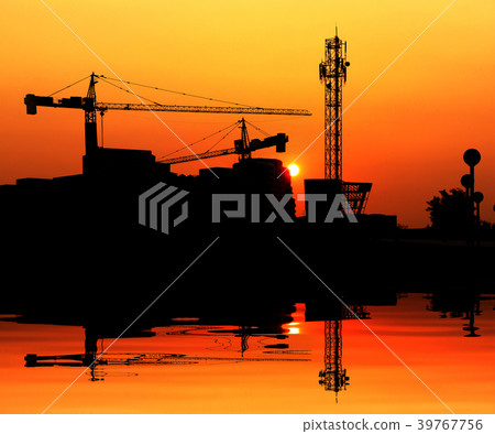 Silhouette crane construction building at sunset Silhouette crane construction building at sunset 39767756