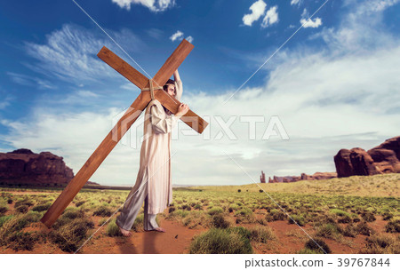 Great martyr with cross in desert, sun rays 39767844