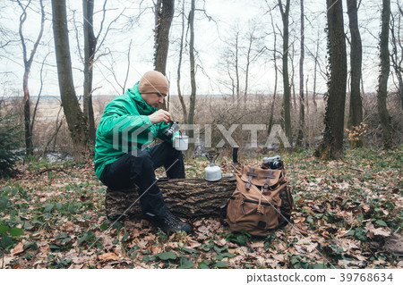 Man with backpack in wild forest 39768634
