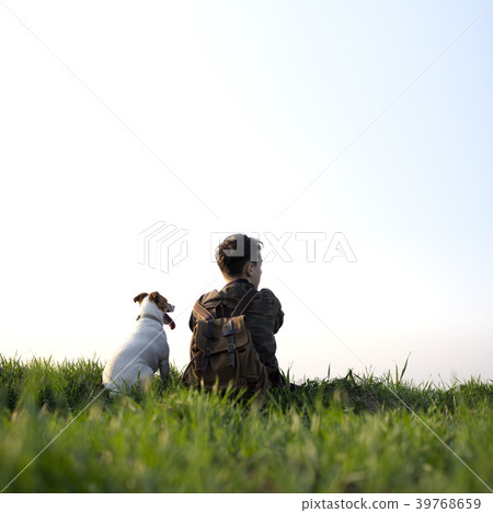 Teenager on green lawn with small white dog Teenager on green lawn with small white dog 39768659