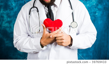 Doctor holding a red heart toy Doctor holding a red heart toy 39769410