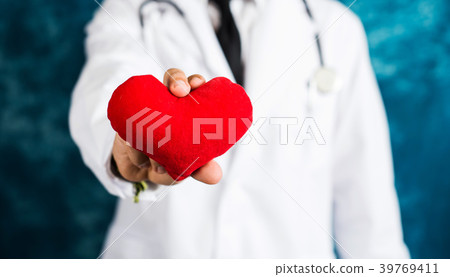 Doctor holding a red heart toy Doctor holding a red heart toy 39769411