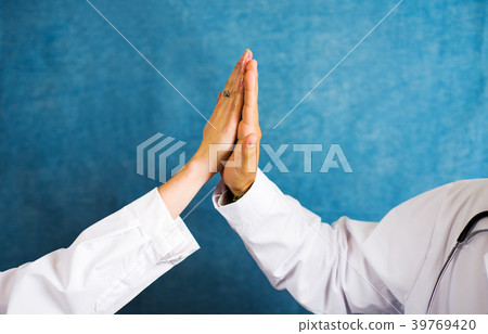 Two doctors doing high five close up Two doctors doing high five close up 39769420