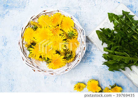 Dandelion flowers in wicker bowl top view Dandelion flowers in wicker bowl top view 39769435