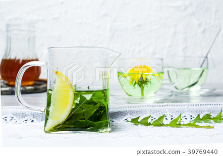 Dandelion tea and fresh flowers on a table 39769440