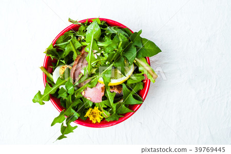 Dandelion salad with eggs meat and lemon in a bowl Dandelion salad with eggs meat and lemon in a bowl 39769445