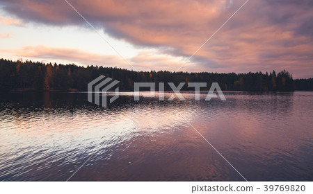 Colorful clouds over still lake in evening Colorful clouds over still lake in evening 39769820