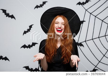 Halloween Concept - Beautiful witch holding hand Halloween Concept - Beautiful witch holding hand 39769844
