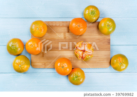 Fresh orange-green mandarines on the blue table 39769982