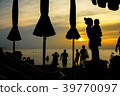 Silhouette Mother embracing baby in arms on beach 39770097
