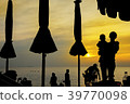 Silhouette Mother embracing baby in arms on beach 39770098