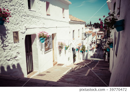 Picturesque street of Mijas with flower pots Picturesque street of Mijas with flower pots 39770472