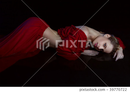 Woman in red dress in the water. 39770722
