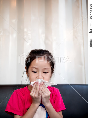 Young Asian girl wiping her mouth after snack Young Asian girl wiping her mouth after snack 39773455
