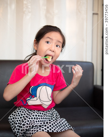 little asian child girl eating toast on the sofa little asian child girl eating toast on the sofa 39773456