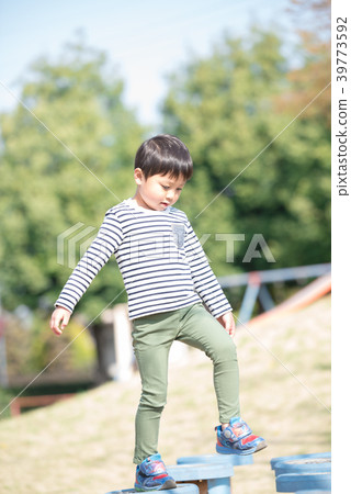 A boy playing in a park A boy playing in a park 39773592