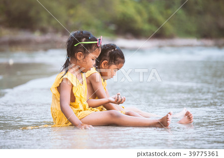 Two asian child girl sitting and playing with sand 39775361