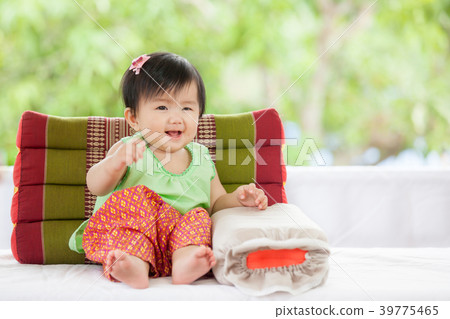 Cute asian baby girl smile and sitting with pillow Cute asian baby girl smile and sitting with pillow 39775465