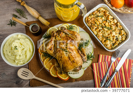 Feasting - stuffed roast chicken with herbs Feasting - stuffed roast chicken with herbs 39777071