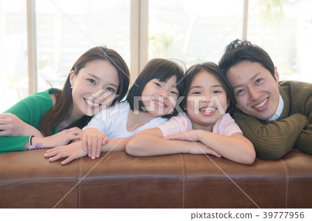 Smiling primary schoolchild two sisters and young couple four family Smiling primary schoolchild two sisters and young couple four family 39777956