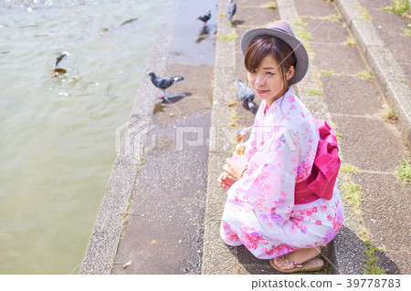 A woman crouching in a yukata A woman crouching in a yukata 39778783