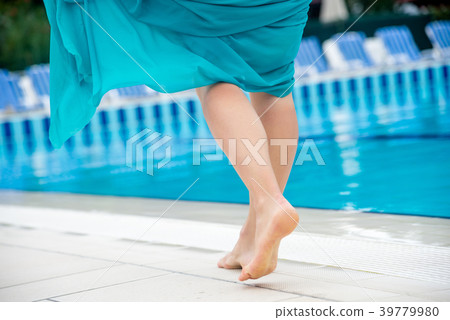 Woman legs in a swimming pool. 39779980