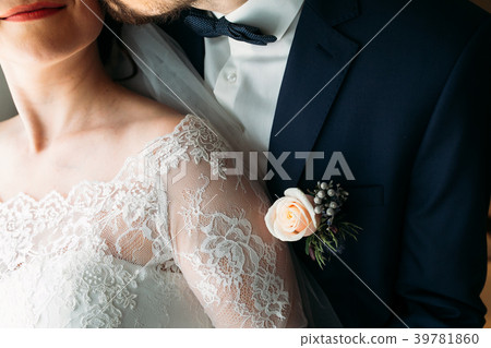 Boutonniere on the lapel of the groom Boutonniere on the lapel of the groom 39781860