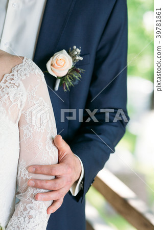 The bridegroom embraces the bride's shoulder The bridegroom embraces the bride's shoulder 39781861