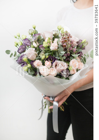 two bouquet of beautiful flowers in women's hands 39783641