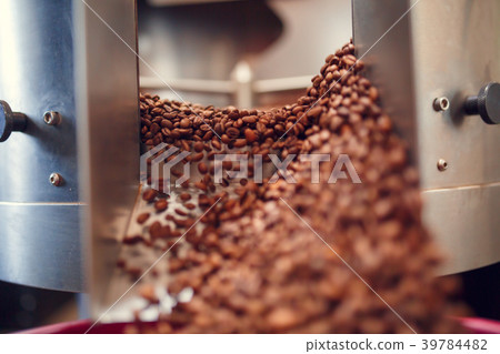 Photo of falling roasted coffee beans from roaster Photo of falling roasted coffee beans from roaster 39784482
