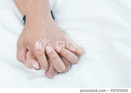 Hands stranglehold of couple lovers on a bed  39785084