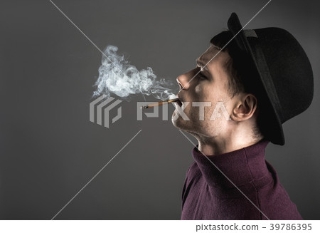 Serious young man wearing modern hat Serious young man wearing modern hat 39786395