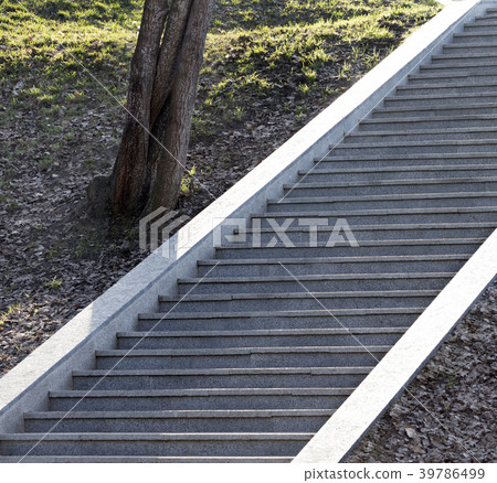 Steps of a granite ladder rising upwards Steps of a granite ladder rising upwards 39786499