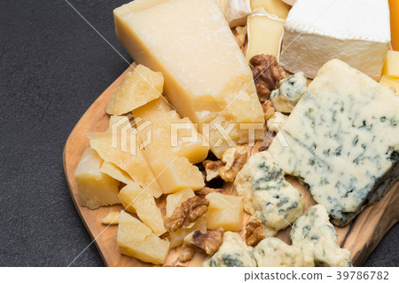 various types of cheese on wooden board 39786782