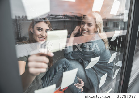Two glad women sharing their business ideas Two glad women sharing their business ideas 39787088