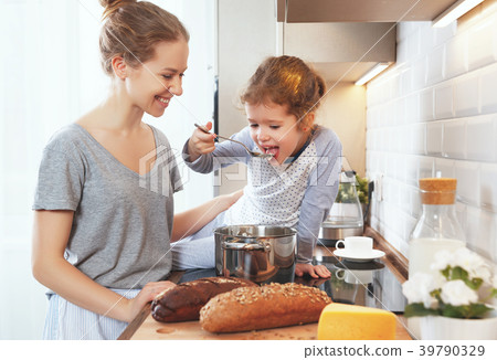 preparation of family breakfast. mother and child daughter cook preparation of family breakfast. mother and child daughter cook 39790329