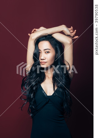 Beautiful asian woman in black dress posing in studio 39790538