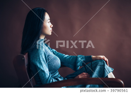 Profile portrait of asian beautiful woman sitting in chair 39790561