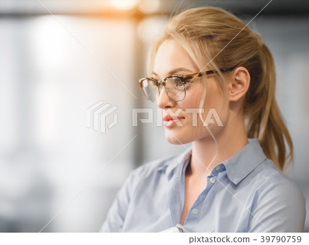 Confident blond woman thinking about her career Confident blond woman thinking about her career 39790759