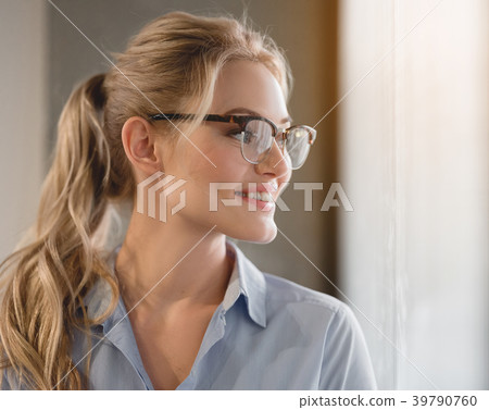 Cheerful young woman planning her future career Cheerful young woman planning her future career 39790760