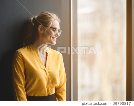 Elegant business lady looking over the window 39790817
