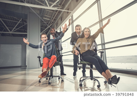Smiling partners riding on chairs Smiling partners riding on chairs 39791848