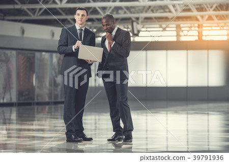 Pensive employers working with gadget 39791936