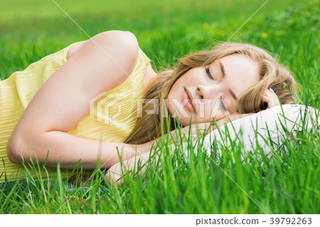 Woman sleeping on grass Woman sleeping on grass 39792263