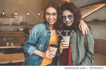 Carefree female friends having rest in cozy cafe Carefree female friends having rest in cozy cafe 39792851