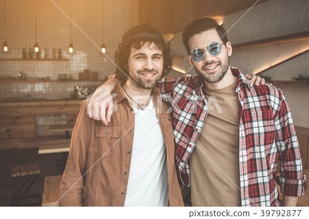 Cheerful fellows posing in friendly embrace 39792877